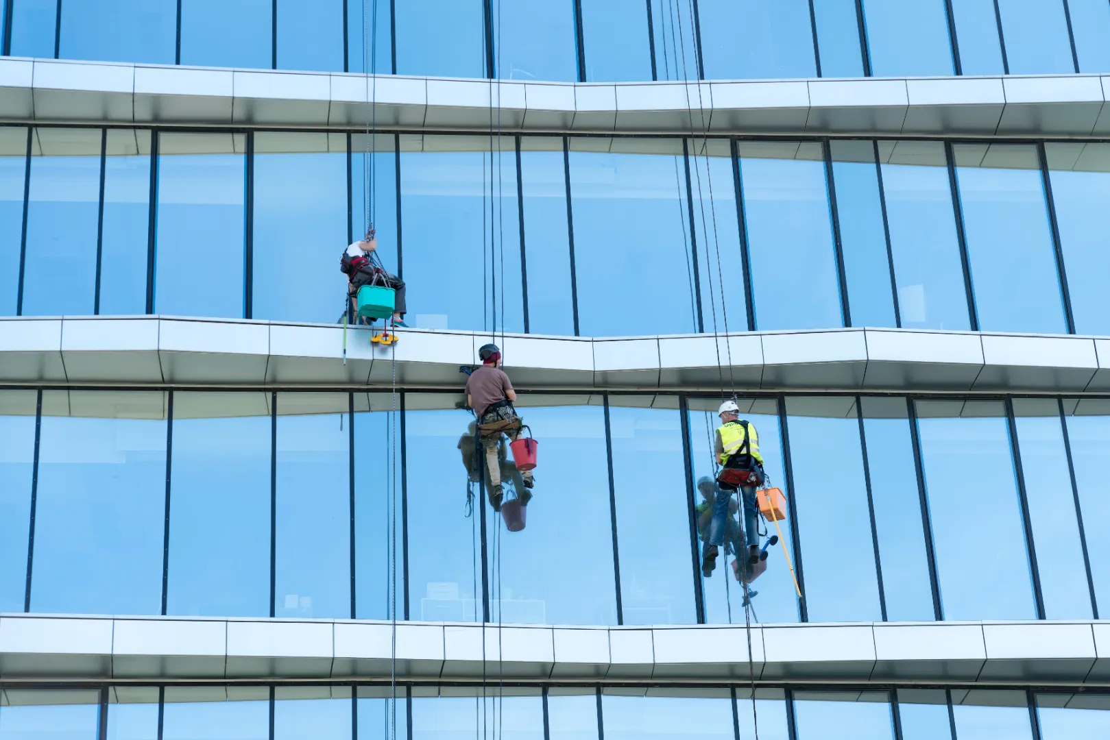 Window cleaners working on the exterior of a high-rise building