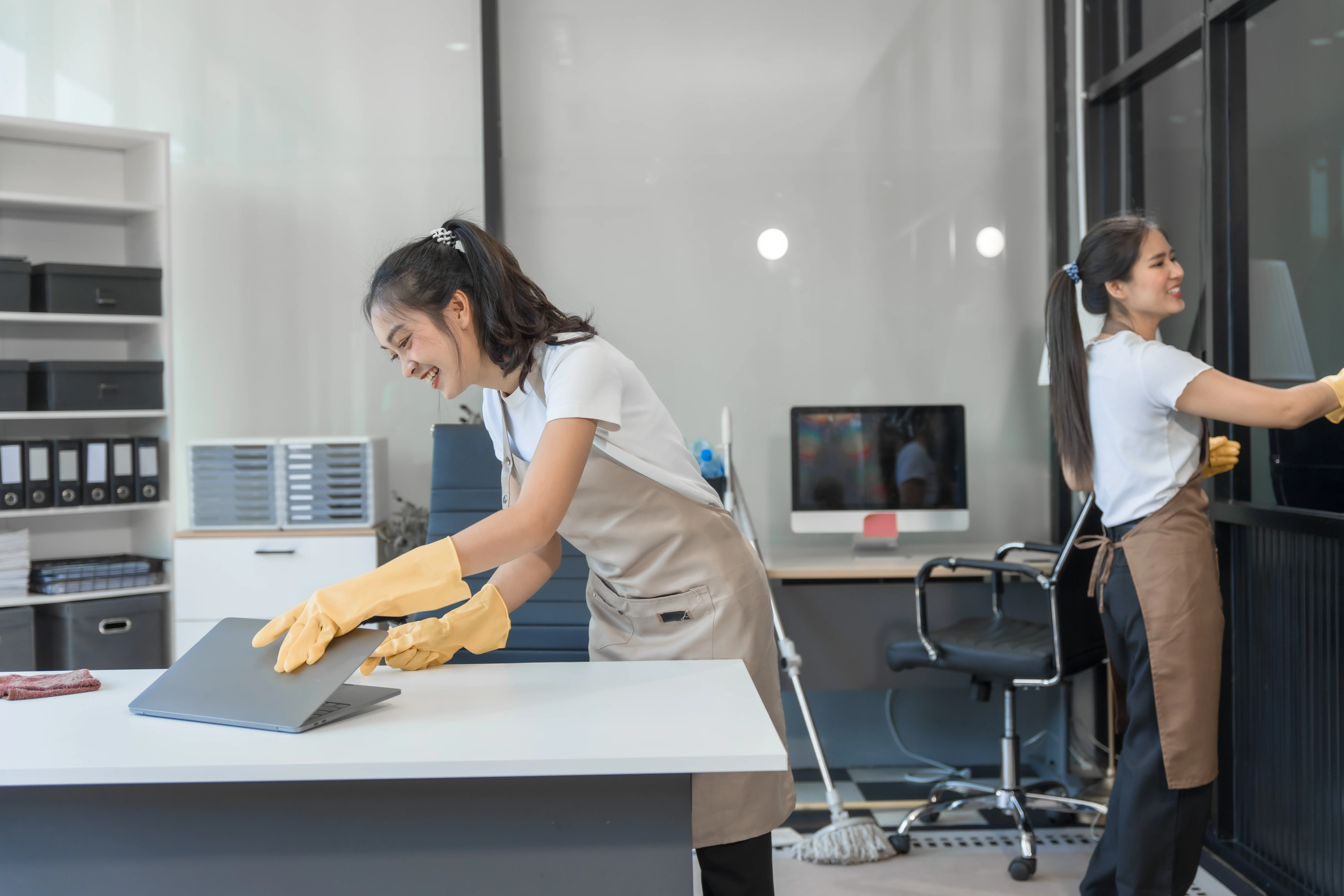 Commercial cleaning staff sanitizing an office breakroom and kitchen